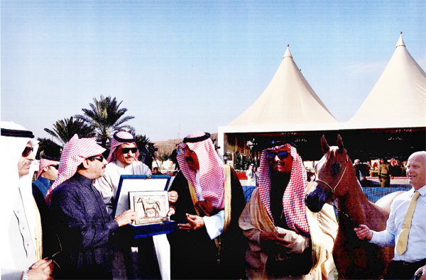 L-R: Dr. Fahad Bin Abdul Rahman Balghinaim, Minister of Agriculture;  Mohammed bin Abdallah Bin Mohammed Al Subaie, Owner; Khalid Bin Abdallah Al Thoum, Head of Registration & Shows at KAAHC; HRH Prince Faisal Bin Abdallah Bin Mohammed Al Saud; Mr. Sami Bin Suleiman Al Nohait, WAHO Executive Committee and Supervisor General of KAAHC;  Hawaizin Al Muawd, 2013 WAHO Trophy Winner, Saudi Arabia; Ryan Jones (Trainer and handler).