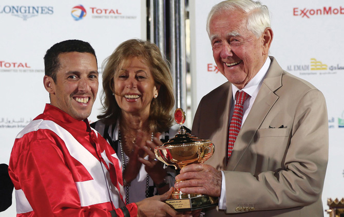 WAHO's President Emeritus, Dr. Hans-J. Nagel, with his wife, Nawal presenting the trophy to jockey Aoubed